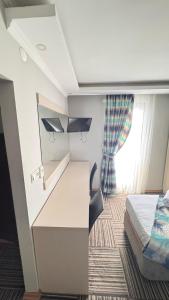 a small room with a bed and a desk at Alya Suite Rezidans in Trabzon