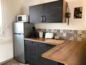 a kitchen with a refrigerator and a wooden counter top at Chalet Belfahy in Belfahy