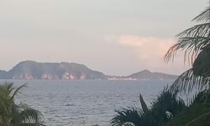 a large body of water with mountains in the background at Apo Breeze Resort in Sampong