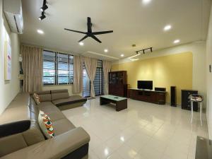 a living room with a couch and a tv at Vintage CoLiving 2Storey Haus in Bukit Mertajam