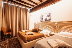 Postel nebo postele na pokoji v ubytování Hotel Domus Tiberina