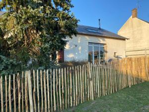 a wooden fence in front of a house at La Grange d 'Escrennes in Escrennes