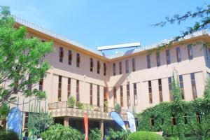 a large building with a lot of windows at Lush Garden Hostel in Arusha