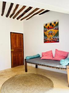 a room with a bench and a painting on the wall at Two Bedroom Private Apartment in Shela, Lamu in Shela
