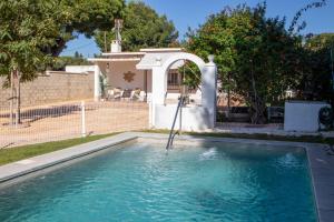 una piscina con cenador junto a una casa en EL ENCANTO Chiclana, en Chiclana de la Frontera