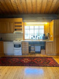 a kitchen with a sink and a stove top oven at Villa Havu in Kuusamo