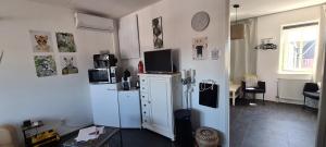 a living room with a refrigerator and a table at Airbnb Meppel Centrum in Meppel