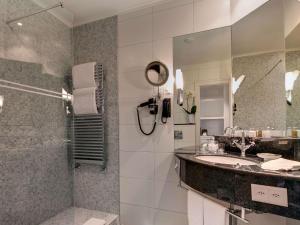 a bathroom with a sink and a shower at Fairmont Le Montreux Palace in Montreux