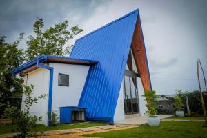 a house with a blue roof at La Prime Ceylon Villa in Beruwala