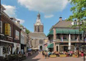 a city street with a clock tower in the background at Airbnb Meppel Centrum in Meppel