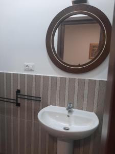 a bathroom with a sink and a mirror at B&B Borgo Antico in Taranto