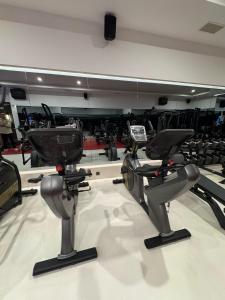 a gym with a bunch of exercise bikes at Granada Luxury Red Adult Only in Alanya