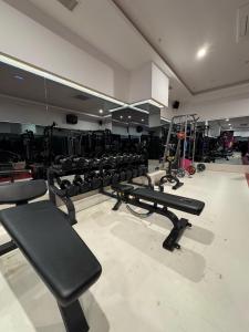 a gym with a row of benches and equipment at Granada Luxury Red Adult Only in Alanya