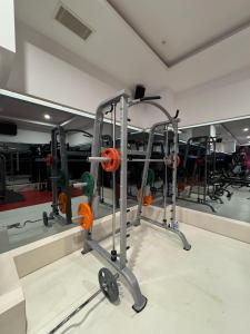 a gym with a row of equipment in a room at Granada Luxury Red Adult Only in Alanya