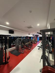 a gym with rows of treadmills and machines at Granada Luxury Red Adult Only in Alanya