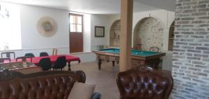 a room with a pool table and some chairs at Relais Golf et Champagne in Villers-Agron-Aiguizy
