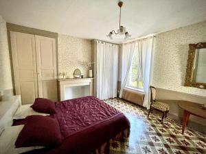 a bedroom with a bed and a table and a window at Relais Golf et Champagne in Villers-Agron-Aiguizy