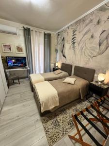 a bedroom with two beds and a wall with a mural at Verona green harmony in Verona