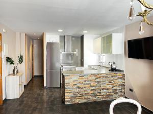 a kitchen with a sink and a refrigerator at Mirador mar in L'Ametlla de Mar