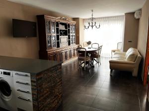 a living room with a table and a dining room at Mirador mar in L'Ametlla de Mar
