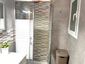 a shower with a glass door in a bathroom at Mirador mar in L'Ametlla de Mar +23 photos