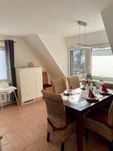a dining room with a wooden table and chairs at Ferienwohnung Paul in Papenburg +29 photos