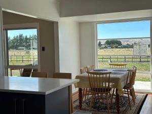 a kitchen and dining room with a table and chairs at Greytown Martinborough mansion in Greytown
