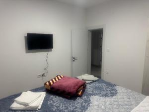 a bedroom with a bed with a pillow on it at Vila AS Krimovica in Krimovice