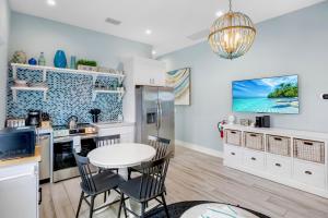 a kitchen with white cabinets and a table and chairs at Villa #6 Starfish in Holmes Beach