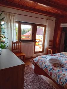 a bedroom with a bed and a large window at Family Home in Cheia