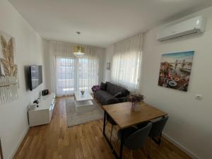 a living room with a couch and a table at Apartman Čapljina in Čapljina