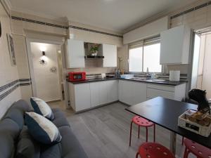 a kitchen with a couch and a table in a room at Villarreal Sant Pascual in Villareal