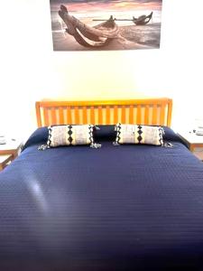 a blue bed with a pillow on top of it at Sicily & Sun Letojanni Taormina in Letojanni
