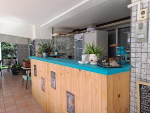 a restaurant with a blue counter with plants on it at Hotel Sogno in Cesenatico