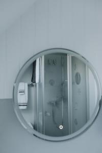 a mirror with a reflection of a shower in it at Küsten Auszeit in Wremen +18 photos