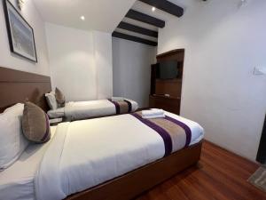 Ένα ή περισσότερα κρεβάτια σε δωμάτιο στο Hotel New Era