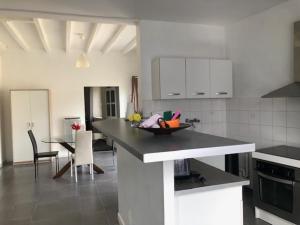 a kitchen with a table and a dining room at Maison entre Saumur et Montreuil Bellay La Motte in Artannes-sur-Thouet