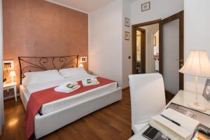 a bedroom with a bed and a desk with a computer at VeronaInFlat - Castle View in Verona