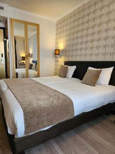Postel nebo postele na pokoji v ubytování ATN Hôtel