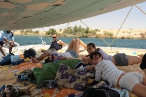a group of people laying on a boat at sailboat in Luxor