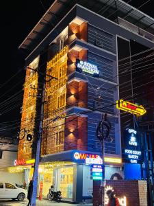 a building with neon signs on the side of it at Royal Mansion Hotel in Cochin
