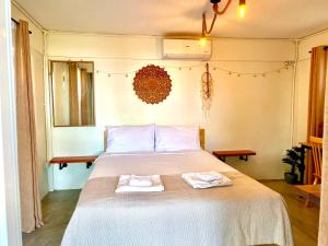 a bedroom with a bed with two towels on it at Cozy Seaview Beach Studio in Ko Phangan
