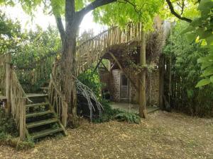 a staircase leading up to a house with a tree at La cachouette in Bressuire