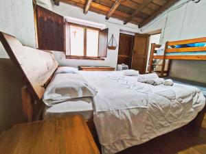 A bed or beds in a room at Case Rurali Pentedattilo