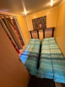 a small room with two bunk beds in it at Green Camping in Gălăoaia