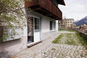 a building with a door on the side of a street at Chasa Plazzetta in Scuol