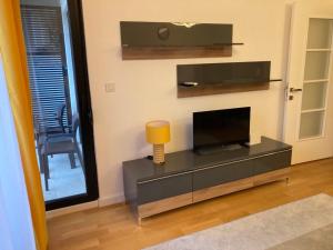 a living room with a flat screen tv on a entertainment center at Sears Residence Apartments in Tivat