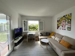a living room with a couch and a table at Menorca Palm Villa in Cala en Blanes