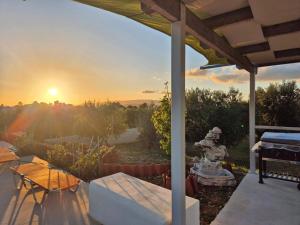 a view of the sunset from the patio of a house at tzogias apartments helen in Argostoli