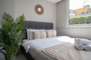 A bed or beds in a room at Heart Of Athens Apartments